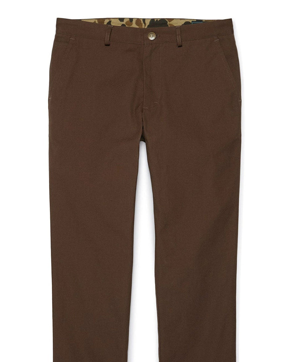 A pair of brown Heritage Pants made from Duck Cotton Canvas, featuring a tailored fit and bar tack stitching at high stress points.