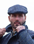 Abraham Moon Tweed Alfred Flat Cap in Royal Navy, on model
